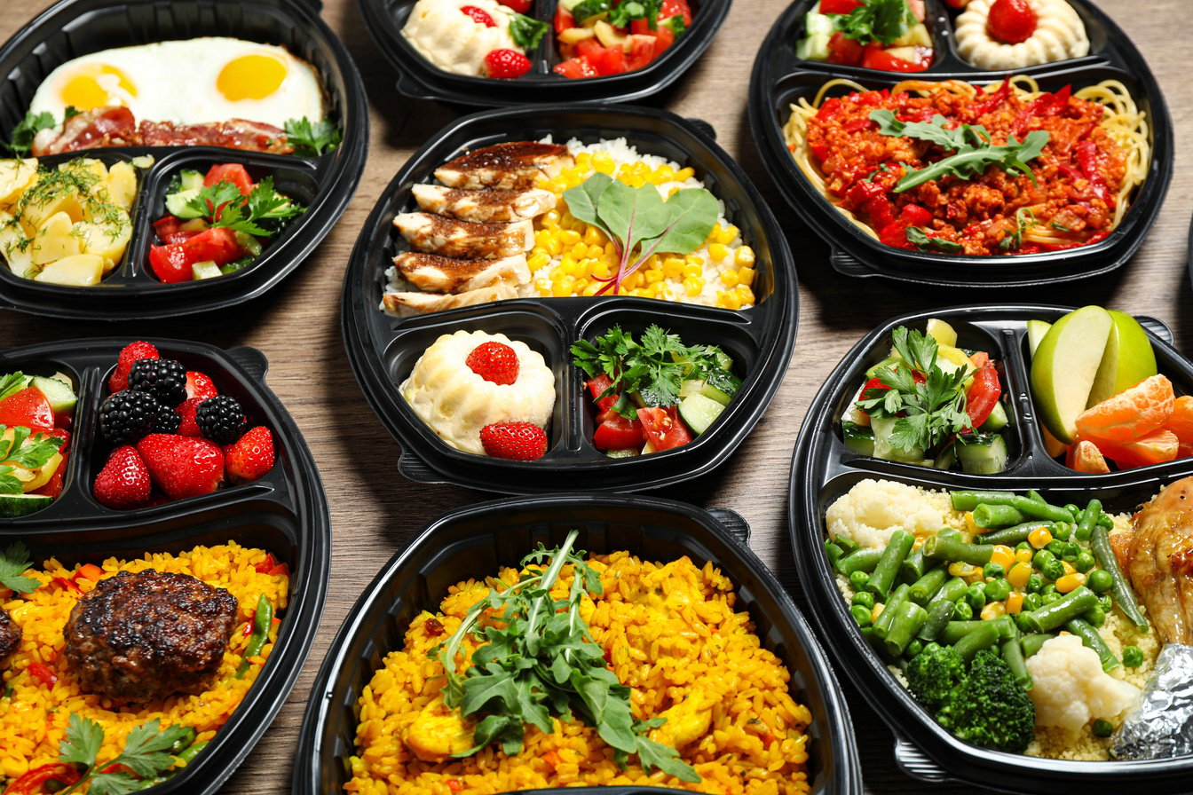 Lunchboxes with Different Meals on Table. Healthy Food Delivery